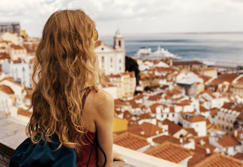 A landscape shot of a young female traveler enjoying the view in Alfama Lisbon Portugal