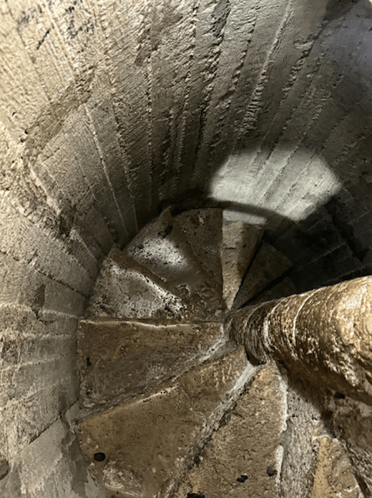 Looking down the dark, narrow, and claustrophobic spiral stone staircase inside the 17th-century Ottoman Minaret in Eger.