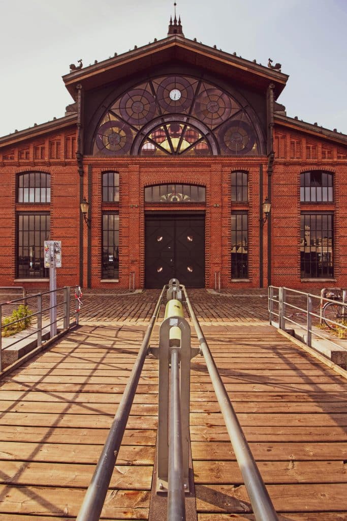 Exterior view of the historic Altona Fish Auction Hall (Fischauktionshalle) in Hamburg near the Elbe river waterfront.